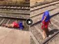 रेल्वे रुळांवर फोनवर बोलत बसली होती तरुणी, अंगावरुन ट्रेन गेली तरी... व्हायरल व्हिडिओ - Marathi News | Viral Video Of Girl Sitting on Railway Track Train Passed Over Her : The girl was sitting on the railway tracks talking on the phone, even though the train ran over her... viral video | Latest sakhi News at Lokmat.com