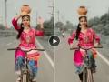 डोक्यावर मातीचा कलश घेऊन सायकल चालवत करतेय डौलदार डान्स, बघा तरुणीचा व्हायरल व्हिडिओ - Marathi News | Women doing classical dance while driving cycle and balancing clay pot on her head | Latest sakhi News at Lokmat.com