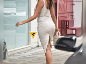 Nora Fatehi drives up in a white Mercedes wearing a white bodycon