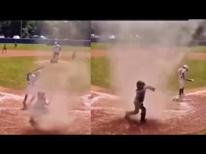 Player trapped in tornado on playground umpire saved life shocking video | चक्रीवादळात अडकला होता 7 वर्षाचा खेळाडू, अपांयरने असा वाचवला त्याचा जीव; व्हिडीओ व्हायरल