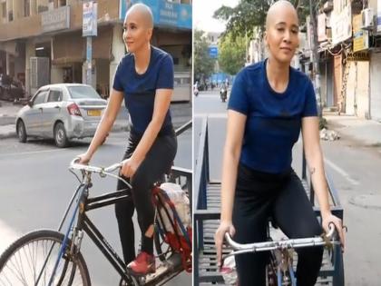 Beautiful girl without hair drove a rickshaw people says like this viral video | VIDEO : बाल्ड लूक असलेल्या तरूणीची सोशल मीडियावर रंगली चर्चा, लोक म्हणाले - काय अदा आहे!