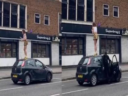 Driver punches a woman as she dances on his car roof in London | अचानक कारच्या छतावर चढून डान्स करू लागली महिला, मालकाने शिकवला असा धडा की...