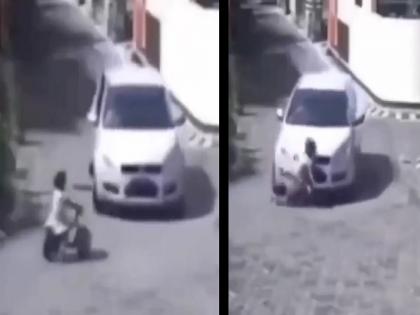 A car wheel went over the stomach of a child; Fortunately she saved , watch the VIDEO... | चिमुकलीच्या पोटावरुन गेले कारचे चाक; सुदैवाने वाचला जीव, पाहा VIDEO...