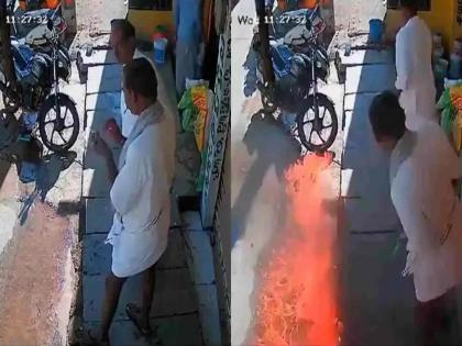 After lighting the bidi match stick was thrown on the road and huge fire broke out video viral | VIDEO: फिल्मी स्टाईलने बिडी पेटवली अन् काडी फेकली; क्षणात बाईक, दुकाने झाली खाक