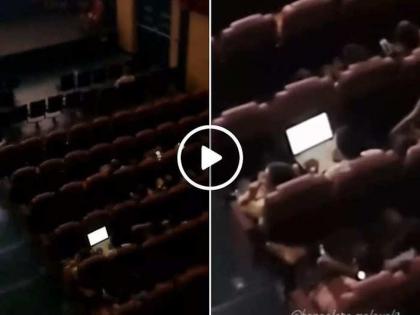 Viral Video Workaholic or work pressure man working while watching movie in theatre bengaluru video | Viral Video : वर्कोहोलिक की वर्क प्रेशर… थिएटरमध्ये फिल्म पाहताना काम करताना दिसला, लोक म्हणाले…