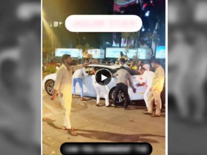 Viral Funny Video of Luxury Car stuck on Speed breaker of Mumbai Roads Mumbaikars come help to rescue trending topic | Video: धन्य ते मुंबईचे रस्ते.... स्पीड ब्रेकरवर अडकली आलिशान जग्वार कार.. अखेर सामान्य मुंबईकरच आले मदतीला