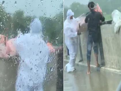 Man in PPE kit throws body into river in UPs Balrampur incident caught on camera | CoronaVirus News: धक्कादायक! दोघांनी कोरोना रुग्णाचा मृतदेह नदीत फेकला; व्हिडीओ व्हायरल