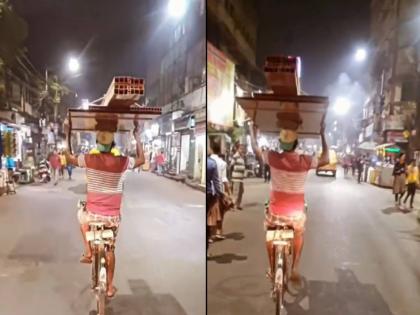 Viral News A young man rode a bicycle with several kilos of luggage on his head, an IPS officer shared the video | कष्टाला पर्याय नाही! डोक्यावर अनेक किलोंचे सामान घेऊन तरुणाने चालवली सायकल, IPS अधिकाऱ्याने शेअर केला व्हिडिओ