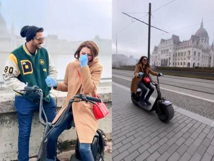 Hansika Motwani rides e scooter during europe honeymoon with Sohael Kathuriya watch video | लग्नानंतर पती सोहेलसोबत युरोपमध्ये हनीमून एन्जॉय करतेय हंसिका, बुडापेस्टच्या रस्त्यावर दिसली स्कूटर चालवताना