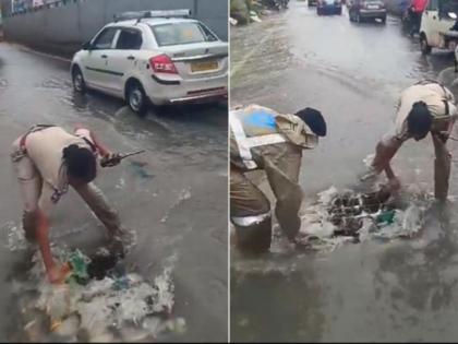 police cleaning drain itself while traffic disrupt due to water on road in hyderabad video viral | Video - रस्त्यावर पाणीच पाणी, वाहतुकीला फटका; नाला साफ करण्यासाठी पोलिसाचा पुढाकार