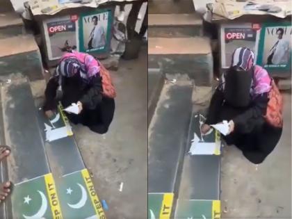 Viral Video: Crowd Confronts Burqa-Clad Woman As She Removes Sticker Of Pakistan Flag From Stairs At Vile Parle Station In Mumbai | रेल्वे स्थानकाच्या पायऱ्यांवर पाकिस्तानी ध्वज चिकटवला; पाहताच महिलेने घातला गोंधळ, व्हिडीओ व्हायरल Viral Video: Crowd Confronts Burqa-Clad Woman As She Removes Sticker Of Pakistan Flag From Stairs At Vile Parle Station In Mumbai | रेल्वे स्थानकाच्या पायऱ्यांवर पाकिस्तानी ध्वज चिकटवला; पाहताच महिलेने घातला गोंधळ, व्हिडीओ व्हायरल