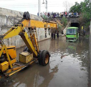 The bus was stuck in the water near the railway tunnel | अमळनेरात रेल्वे बोगद्याजवळील पाण्यात अडकली बस