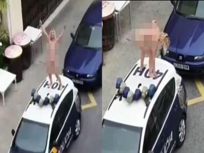 Video : Spain woman strips naked stands atop police car after being called to court for flouting lockdown api | Video : लॉकडाऊनमध्ये थेट पोलिसांच्या गाडीवर निर्वस्त्र होऊन महिलेचा धिंगाणा, पण का?