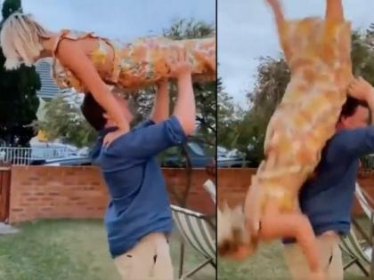 Boyfriend wanted to do stunts by lifting on the head balance disturbed and girlfriend fell on the ground | VIDEO : डोक्यावर उचलून स्टंट करत होता बॉयफ्रेन्ड, बॅलन्स बिघडला आणि गर्लफ्रेन्ड पडली तोंडावर...