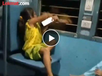 Video girl sitting by train window seat using phone man snatches it through window | Video - बापरे! विंडो सीटवर बसून फोन वापरत होती चिमुकली; अचानक बाहेरून हात आला अन्...