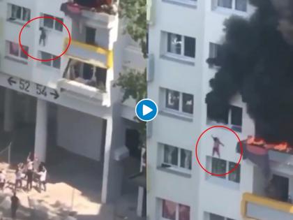 France two kids jump 40 feet from burning building rescuers caught video goes viral | थरारक! बिल्डींगला आग लागल्याने चिमुकल्यांनी खिडकीतून ४० फुटांवर मारली उडी; व्हिडीओ व्हायरल