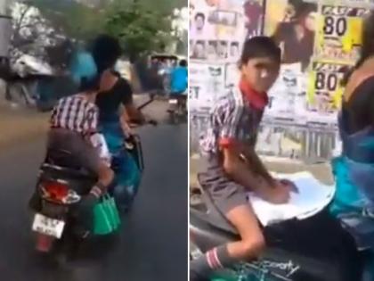 student doing homework on scooty while his mother is driving goes viral on social media | धावत्या स्कुटीवर हा करतोय होम वर्क, नेटकरी म्हणाले इतका अभ्यासू मुलगा जगात सापडणार नाही