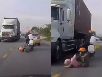 mother saved son in road accident video goes viral from vietnam | Video - शेवटी आईच 'ती'! ट्रकखाली आला मुलगा, 12 सेकंदात 'तिने' असा जीव वाचवला; काय घडलं?