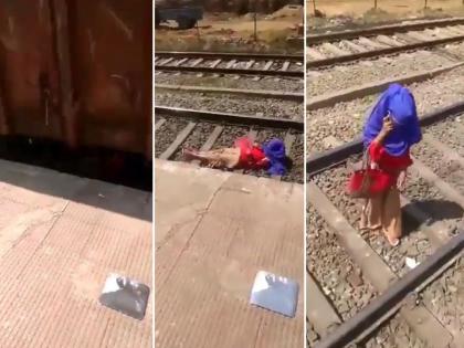 goods train passed on the woman body after that she got busy talking on phone video goes viral on internet | Viral Video: अंगावरुन अख्खी मालगाडी गेली तरीही फोनवर गॉसिप करण्यात बिझी होती महिला, पाहा व्हिडिओ