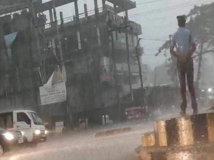 Assam traffic cop stands on duty during storm, becomes social media star | पावसात भिजत कर्तव्य बजावले; व्हिडीओ पाहून पोलिसावर कौतुकाचा वर्षाव! Assam traffic cop stands on duty during storm, becomes social media star | पावसात भिजत कर्तव्य बजावले; व्हिडीओ पाहून पोलिसावर कौतुकाचा वर्षाव!