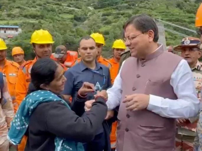 dharali cm pushkar singh dhami inspects flood affected areas gujarati women ties rakhi emotional moment | हृदयस्पर्शी! "तुम्ही माझ्यासाठी श्रीकृष्णासारखे..."; महिलेने साडी फाडून मुख्यमंत्र्यांना बांधली राखी dharali cm pushkar singh dhami inspects flood affected areas gujarati women ties rakhi emotional moment | हृदयस्पर्शी! "तुम्ही माझ्यासाठी श्रीकृष्णासारखे..."; महिलेने साडी फाडून मुख्यमंत्र्यांना बांधली राखी