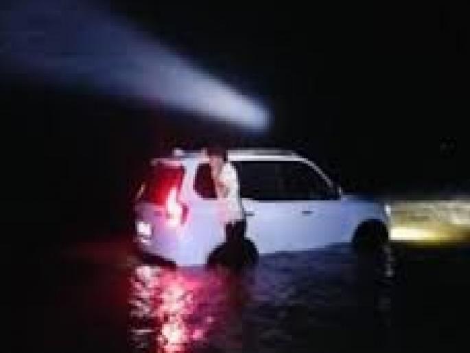 Tourists from Kolhapur took a car to Guhagar beach It got stuck in the tidal water | कोल्हापुरातील पर्यटकांनी समुद्रकिनारी बेफिकिरीने गाडी वाळूवर नेली, भरतीमुळे पाण्यात अडकून पडली