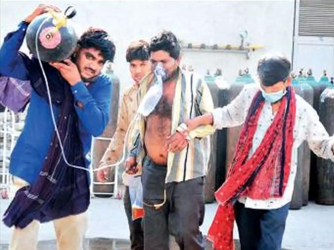 CoronaVirus News in Ahmedabad Kin roam with man oxygen cylinder for 3 days | CoronaVirus News: गुजरात मॉडेल? कोरोना रुग्णासह ऑक्सिजन सिलिंडर घेऊन नातेवाईकांची ३ दिवस वणवण CoronaVirus News in Ahmedabad Kin roam with man oxygen cylinder for 3 days | CoronaVirus News: गुजरात मॉडेल? कोरोना रुग्णासह ऑक्सिजन सिलिंडर घेऊन नातेवाईकांची ३ दिवस वणवण