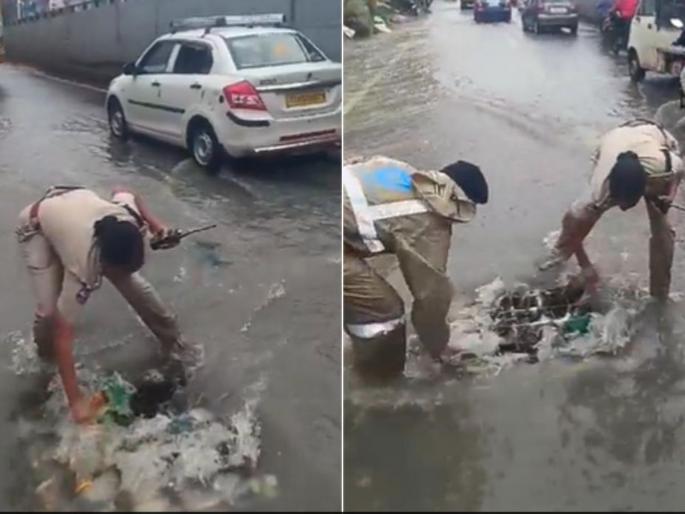 police cleaning drain itself while traffic disrupt due to water on road in hyderabad video viral | Video - रस्त्यावर पाणीच पाणी, वाहतुकीला फटका; नाला साफ करण्यासाठी पोलिसाचा पुढाकार police cleaning drain itself while traffic disrupt due to water on road in hyderabad video viral | Video - रस्त्यावर पाणीच पाणी, वाहतुकीला फटका; नाला साफ करण्यासाठी पोलिसाचा पुढाकार