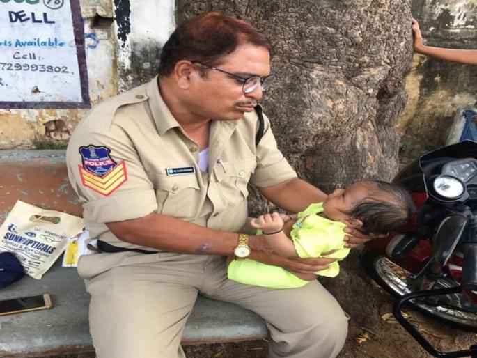 Telangana cop babysits while mother writes exam, wins hearts | वर्दीतील माणुसकी! परीक्षा देणाऱ्या आईसाठी पोलिसाने केला बाळाचा सांभाळ Telangana cop babysits while mother writes exam, wins hearts | वर्दीतील माणुसकी! परीक्षा देणाऱ्या आईसाठी पोलिसाने केला बाळाचा सांभाळ