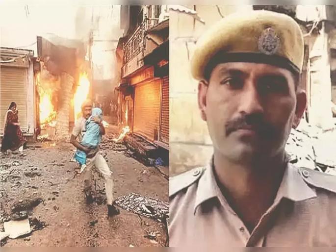 karauli communal clash photo viral of rajasthan police constable netresh sharma know what exactly happened | चिमुकल्याला आगीतून वाचवण्यासाठी कुशीत घेऊन धावला; शूरवीराचा फोटो पाहून तुम्हीही कराल 'कडक सॅल्युट' karauli communal clash photo viral of rajasthan police constable netresh sharma know what exactly happened | चिमुकल्याला आगीतून वाचवण्यासाठी कुशीत घेऊन धावला; शूरवीराचा फोटो पाहून तुम्हीही कराल 'कडक सॅल्युट'