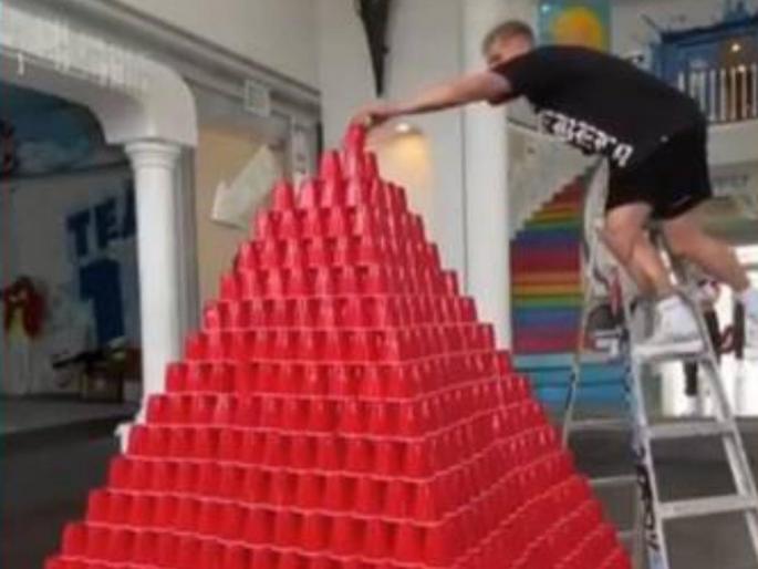 Video : Man falls on pyramid of cups he spent 2 days building in lockdown api | Viral Video : लॉकडाऊनमधे केलेली दोन दिवसांची त्याची मेहनत काही सेकंदात गेला वाया, कशी ती बघा! Video : Man falls on pyramid of cups he spent 2 days building in lockdown api | Viral Video : लॉकडाऊनमधे केलेली दोन दिवसांची त्याची मेहनत काही सेकंदात गेला वाया, कशी ती बघा!