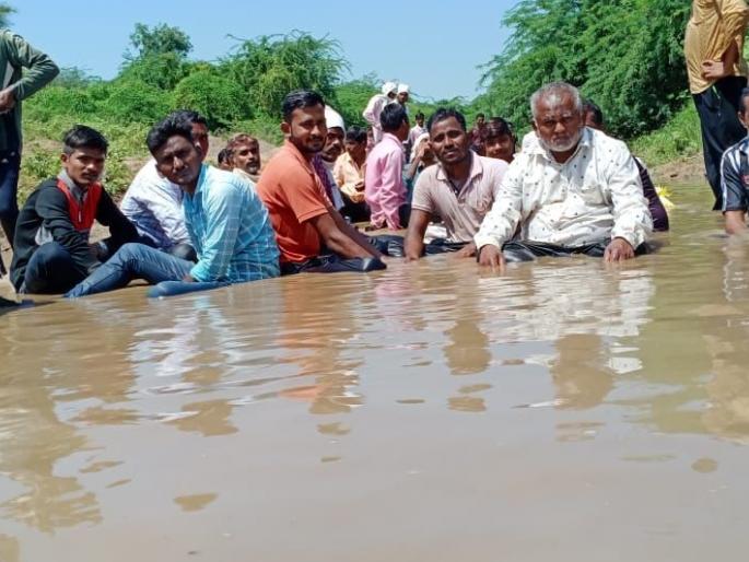 Villagers sit in the river basin and go on a hunger strike | नदीपात्रात बसून ग्रामस्थांचे अन्नत्याग आंदोलन Villagers sit in the river basin and go on a hunger strike | नदीपात्रात बसून ग्रामस्थांचे अन्नत्याग आंदोलन