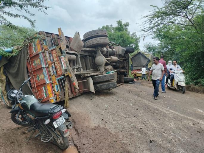 One of the trucks went down the road due to over taking, while the other truck overturned after hitting it | हुल दिल्याने एक ट्रक रस्त्याच्या खाली उतरला, तर दूसरा ट्रक त्यावर धडकून उलटला One of the trucks went down the road due to over taking, while the other truck overturned after hitting it | हुल दिल्याने एक ट्रक रस्त्याच्या खाली उतरला, तर दूसरा ट्रक त्यावर धडकून उलटला