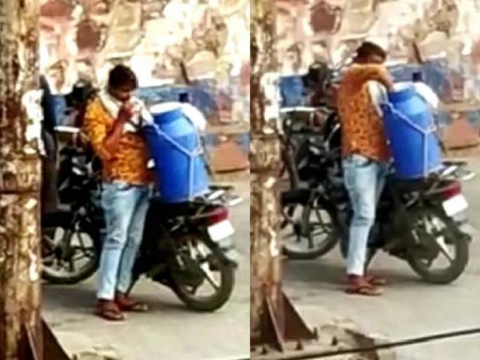 Milkman teeth milk tank video goes viral covid 19 bharatpur rajasthan myb | दुधवाल्यामुळे नागरिकांच्या जीवाशी खेळ; पिशवी दाताने फोडून संपूर्ण शहराला पूरवतो दूध Milkman teeth milk tank video goes viral covid 19 bharatpur rajasthan myb | दुधवाल्यामुळे नागरिकांच्या जीवाशी खेळ; पिशवी दाताने फोडून संपूर्ण शहराला पूरवतो दूध