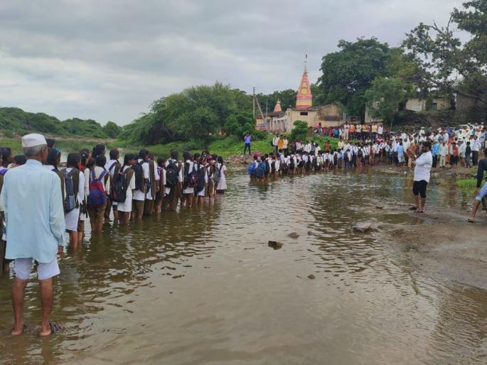 As there is no bridge, the students travel dangerously through the riverbed | पूल नसल्याने विद्यार्थ्यांचा नदीपात्रातून जीवघेणा प्रवास As there is no bridge, the students travel dangerously through the riverbed | पूल नसल्याने विद्यार्थ्यांचा नदीपात्रातून जीवघेणा प्रवास