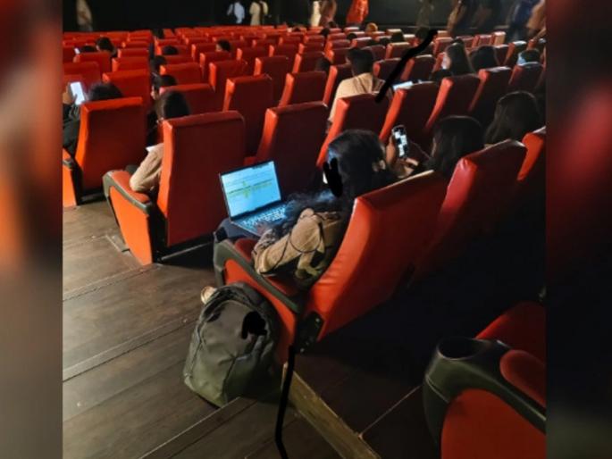 'Work from Cinema Hall': Photo of woman sitting in cinema hall and working goes viral, people say... | 'वर्क फ्रॉम सिनेमा हॉल' चित्रपटगृहात बसून काम करणाऱ्या महिलेचा फोटो व्हायरल लोकं म्हणतात...
