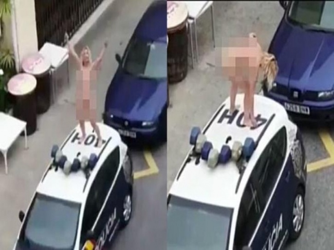 Video: Spain Woman Strips Naked, Stands Atop Police Car 
