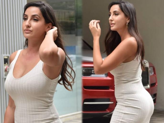 Nora Fatehi drives up in a white Mercedes wearing a white bodycon