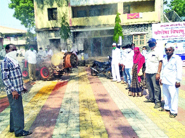 Disinfection spraying at Devgaon | देवगाव येथे जंतुनाशक फवारणी