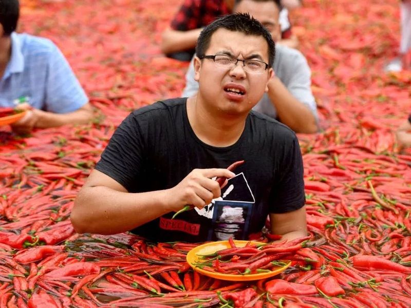 red hot chilli eater downs 50 peppers barely minute contest | अबब...! 68 सेकंदांत 'या' पठ्याने फस्त केल्या 50 झणझणीत मिरच्या