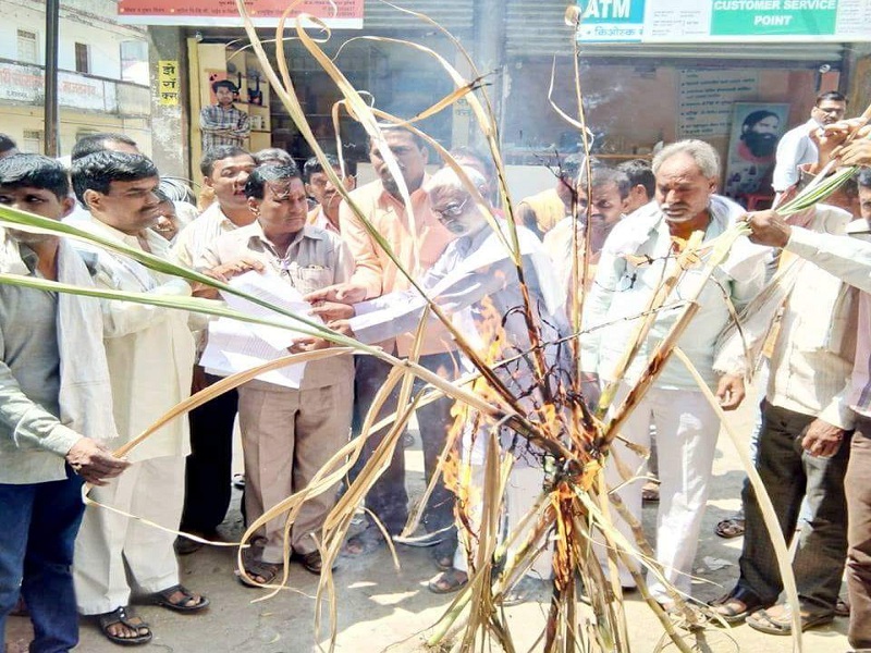 The farmers burn holi of sugarcane infront of Majalgaon market committee | माजलगाव बाजार समितीसमोर शेतकऱ्यांनी केली उसाची होळी 