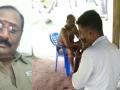 Viral video shows TN cop forced to play flute for official taking oil massage - Hindi News | Viral video shows TN cop forced to play flute for official taking oil massage | Latest politics News at Lokmattimes.com