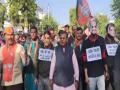 Rajasthan BJP stages unique protest in Udaipur wearing masks of Rajasthan ministers - Hindi News | Rajasthan BJP stages unique protest in Udaipur wearing masks of Rajasthan ministers | Latest politics News at Lokmattimes.com