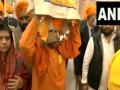 Yogi Adityanath carries Sikh holy book on Veer Bal Diwas - Hindi News | Yogi Adityanath carries Sikh holy book on Veer Bal Diwas | Latest national News at Lokmattimes.com