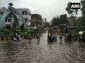 Rescue workers pull out bus from waterlogged Surat street - Hindi News | Rescue workers pull out bus from waterlogged Surat street | Latest national News at Lokmattimes.com
