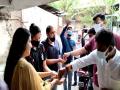 BJP leaders distribute yellow rice to encourage people to take COVID-19 vaccine - Hindi News | BJP leaders distribute yellow rice to encourage people to take COVID-19 vaccine | Latest national News at Lokmattimes.com