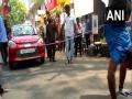 TN polls: Yoga instructor pulls car walking upside down to campaign for AIADMK candidate - Hindi News | TN polls: Yoga instructor pulls car walking upside down to campaign for AIADMK candidate | Latest national News at Lokmattimes.com