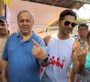 Varun helps his father David Dhawan as they step out to vote in Juhu | Varun helps his father David Dhawan as they step out to vote in Juhu Varun helps his father David Dhawan as they step out to vote in Juhu | Varun helps his father David Dhawan as they step out to vote in Juhu