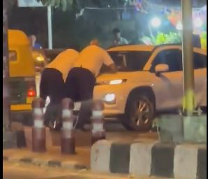 Two traffic cops hang on to car bonnet to stop rash driver near IIT-Delhi | Two traffic cops hang on to car bonnet to stop rash driver near IIT-Delhi