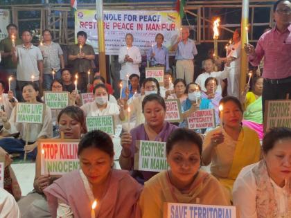 Manipuris in Tripura hold candlelight demonstration seeking normalcy in home state | Manipuris in Tripura hold candlelight demonstration seeking normalcy in home state